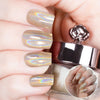 Nails featuring a champagne-gold holographic powder with warm burnt orange and brown undertones.
